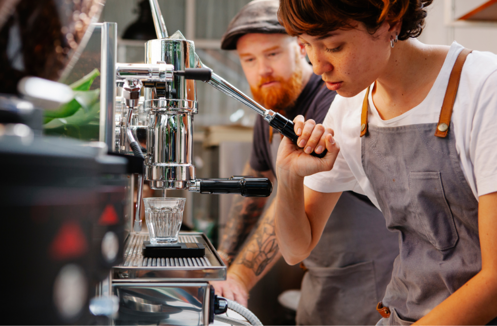 Should You Buy A Manual Espresso Machine? 6 Barista using a manual espresso machine