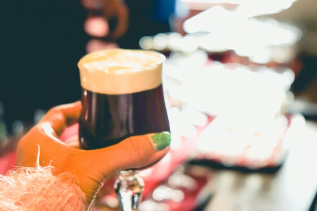 Lady holding a glass of Irish Coffee